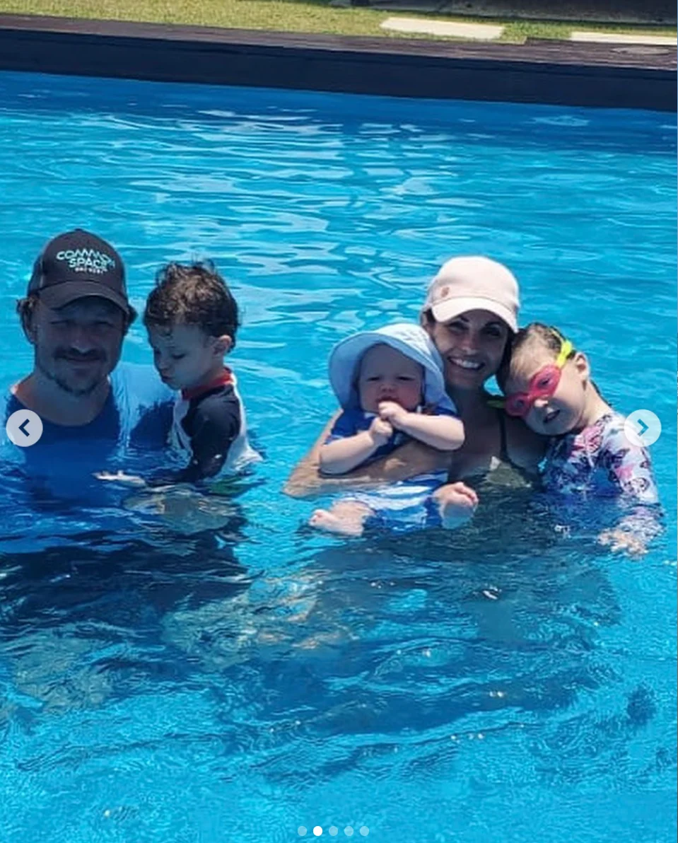 Avery and Cara Knapp in a swimming pool with their children in Puerto Rico