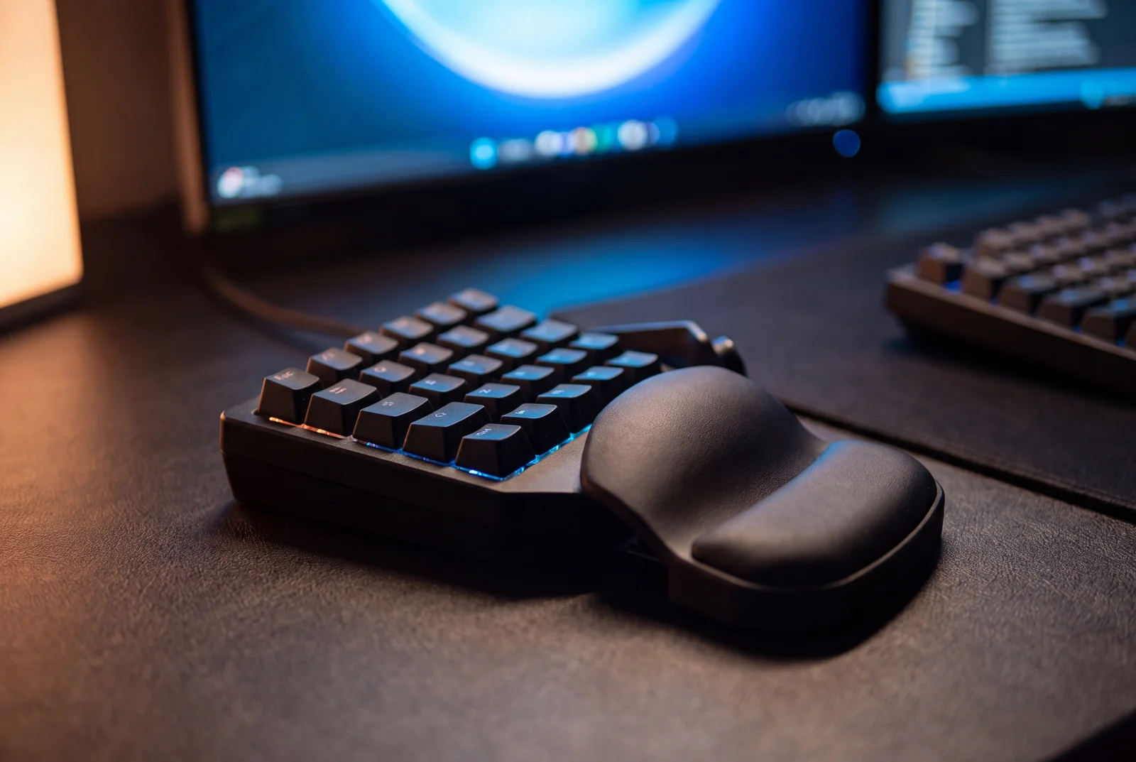 A compact backlit programmable keypad on the desk, used for the shortcuts a radiologist repeats all day